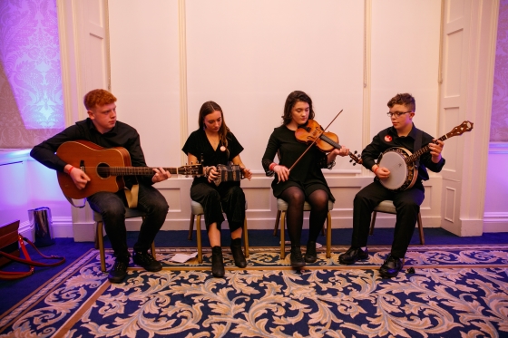 Members of the Music Generation Carlow traditional Irish music senior ensemble Reelig perform for delegates at an event hosted by Bank of America 560x373