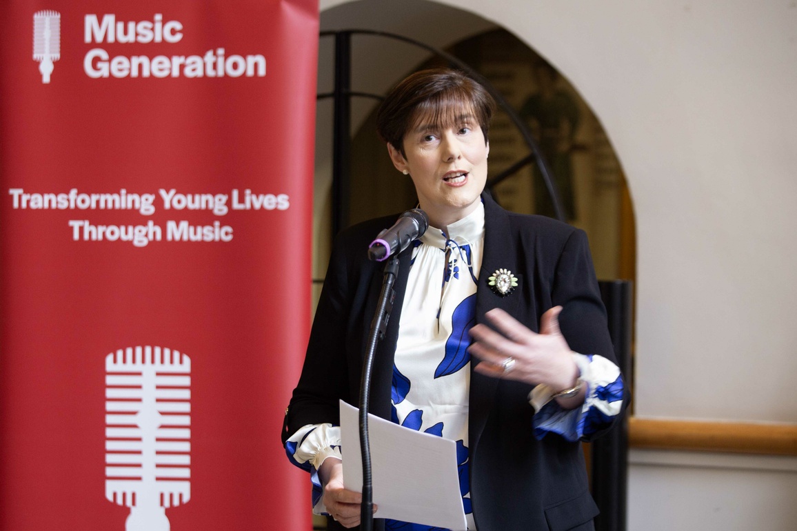 Minister for Education speaking at microphone