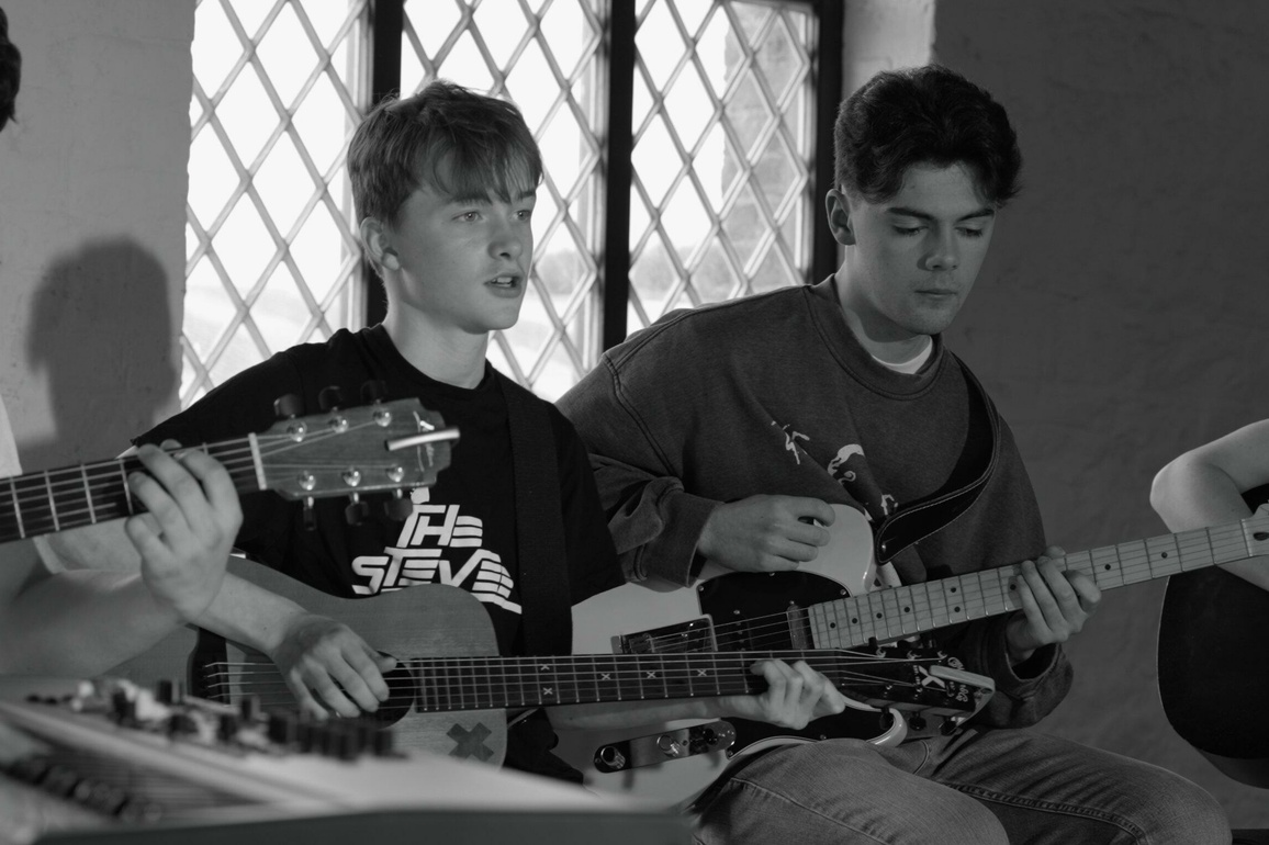 Group of young musicians playing guitars.