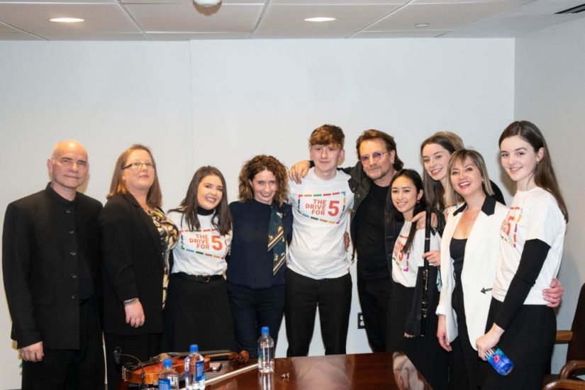 Kerrianne McCardle (Flute); Evelyn McCaul (Harp); Saoirse McGahern (Bodhrán); Iarla McMahon (Uilleann Pipes); and Kim Poole (Fiddle) are joined by U2's Bono in this pic, captured at the launch of The Drive for Five at the UN Headquarters in NYC during February. Photo: Kim Haughton/UN