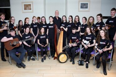 Kerrianne McCardle (Flute); Evelyn McCaul (Harp); Saoirse McGahern (Bodhrán); Iarla McMahon (Uilleann Pipes); and Kim Poole (Fiddle) are joined by U2's Bono in this pic, captured at the launch of The Drive for Five at the UN Headquarters in NYC during February. Photo: Kim Haughton/UN